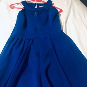 Blue shorts jumpsuit with cape.